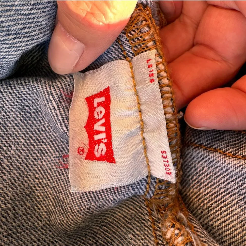 Vintage Levi's 501 button-fly jeans with Y2K's red batwing label